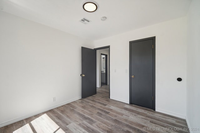 unfurnished bedroom featuring light wood-type flooring