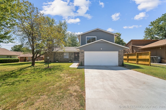 view of front of house featuring a garage and a front lawn