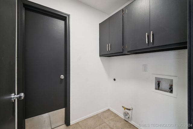 laundry area featuring washer hookup, cabinets, light tile patterned floors, and electric dryer hookup