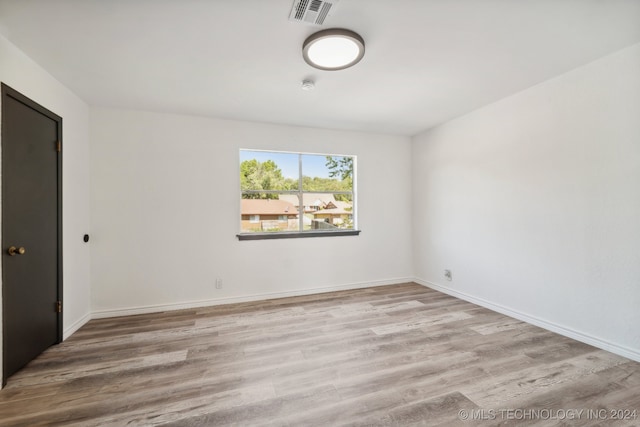 spare room featuring light wood-type flooring