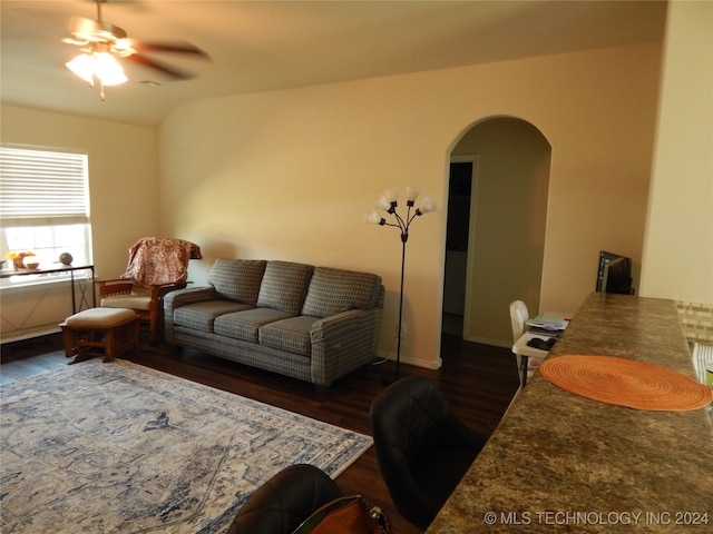 living room featuring dark hardwood / wood-style flooring and ceiling fan