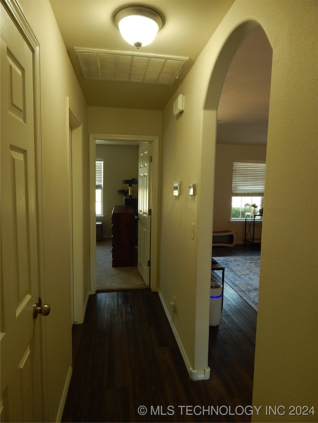 hall with dark hardwood / wood-style floors