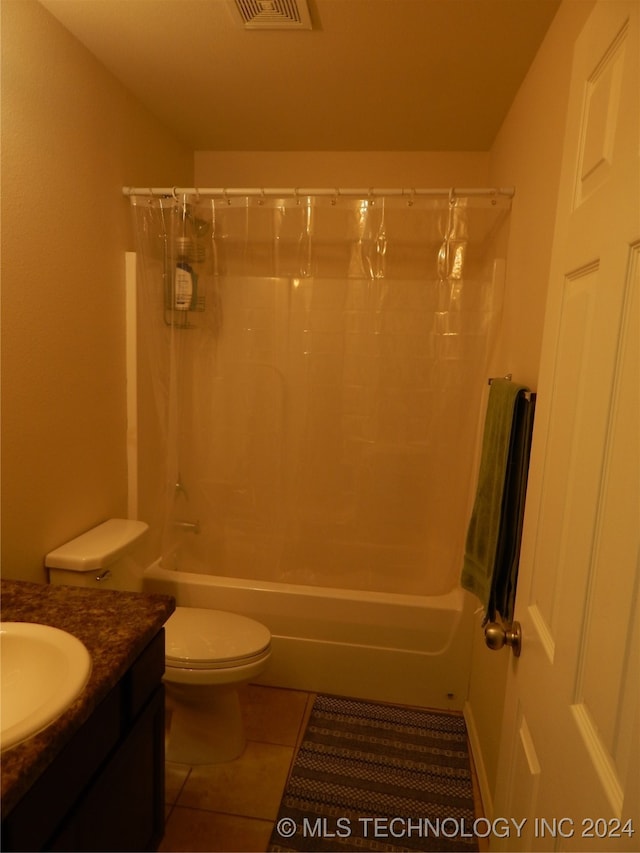 full bathroom with tile patterned flooring, shower / bath combo, vanity, and toilet