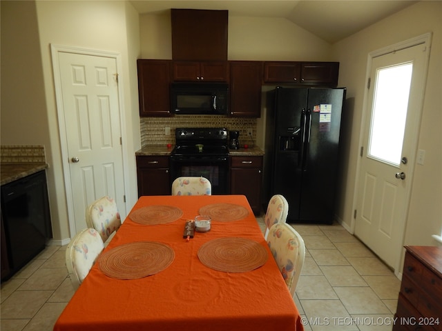 kitchen featuring lofted ceiling, light tile patterned floors, tasteful backsplash, and black appliances