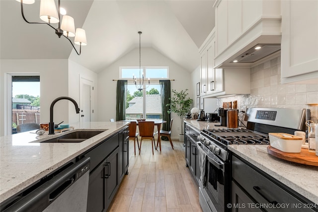 kitchen featuring appliances with stainless steel finishes, white cabinetry, an inviting chandelier, and pendant lighting