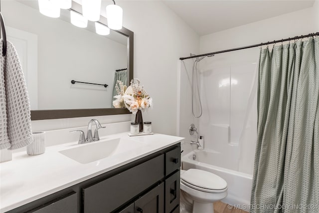 full bathroom featuring shower / bath combo with shower curtain, vanity, and toilet