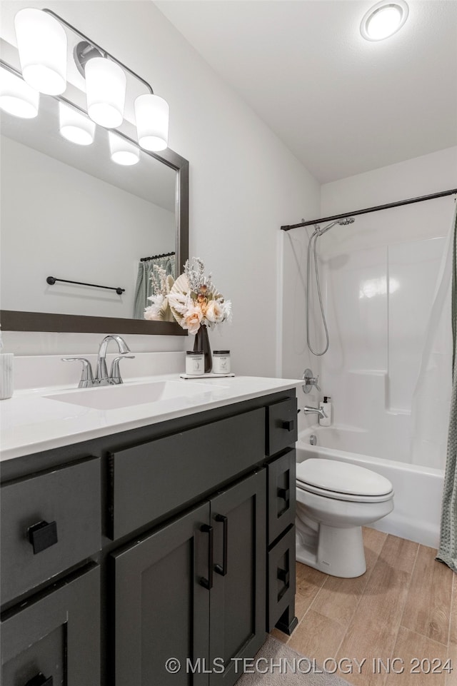 full bathroom with shower / bath combo, vanity, toilet, and hardwood / wood-style flooring