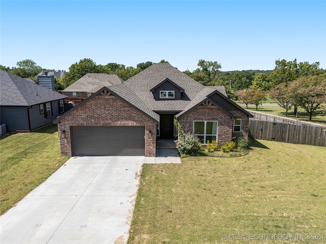 craftsman-style house featuring a garage and a front yard