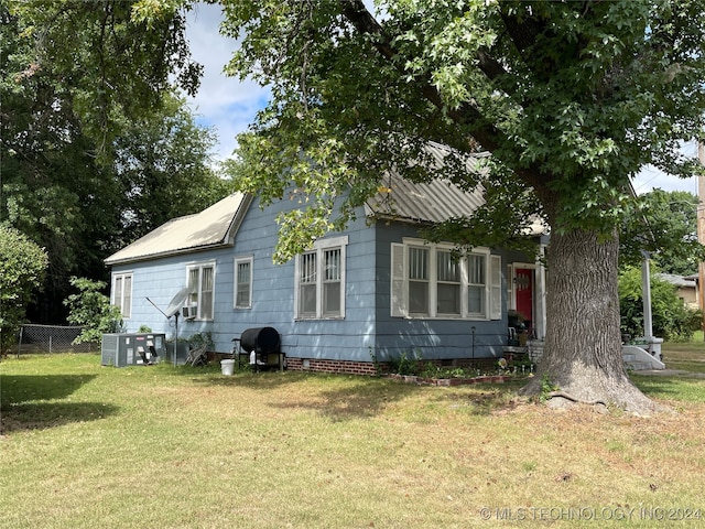 view of home's exterior with a yard