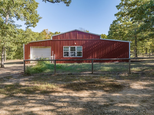 view of side of property with an outbuilding