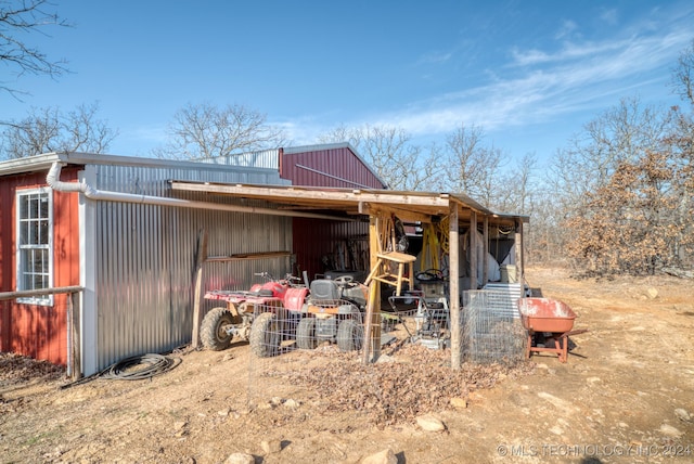 back of house with an outdoor structure