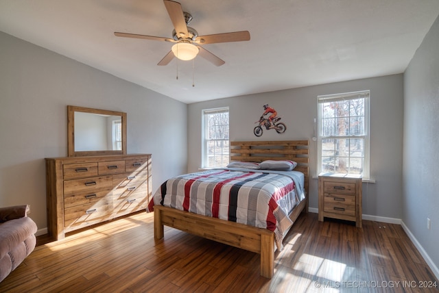 bedroom featuring lofted ceiling, dark wood-type flooring, and ceiling fan