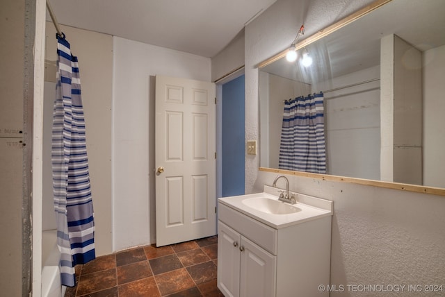 bathroom featuring vanity and shower / tub combo