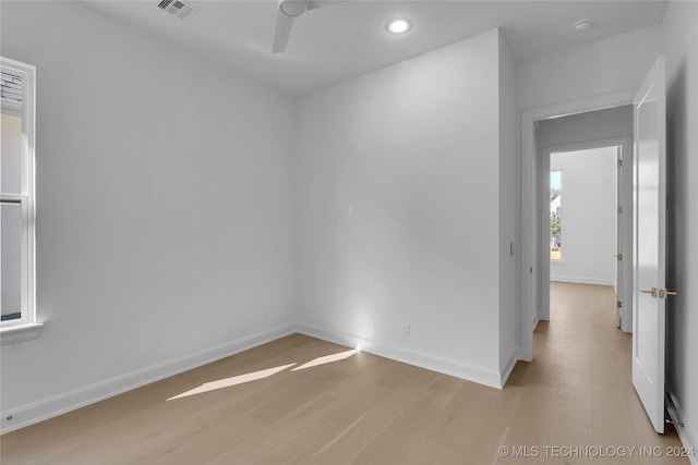 spare room with light hardwood / wood-style floors and ceiling fan