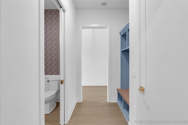 interior space featuring hardwood / wood-style flooring and toilet