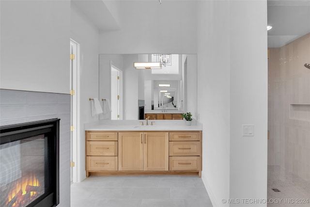 bathroom featuring vanity, a shower, and tile patterned flooring