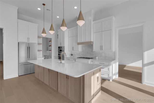 kitchen featuring hanging light fixtures, white cabinetry, a large island, and stainless steel appliances