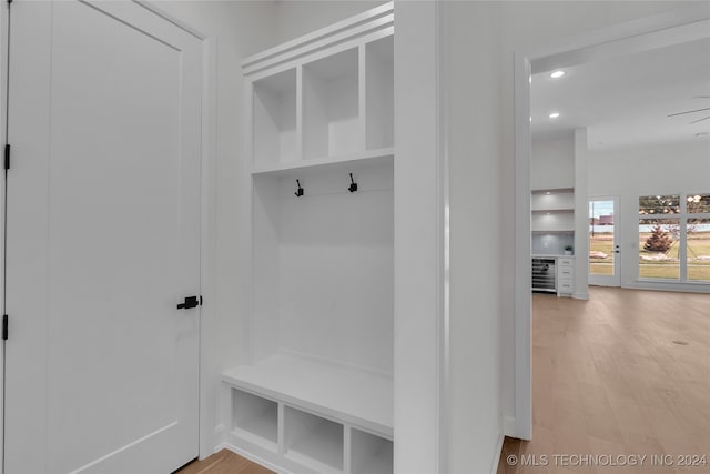 mudroom featuring wood-type flooring and wine cooler