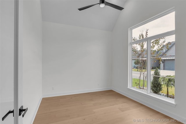 unfurnished room featuring ceiling fan, light wood-type flooring, and vaulted ceiling