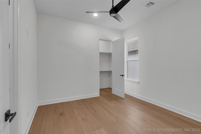 unfurnished bedroom featuring light hardwood / wood-style floors, ceiling fan, and a closet