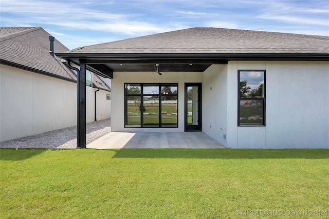 back of house with a patio and a yard