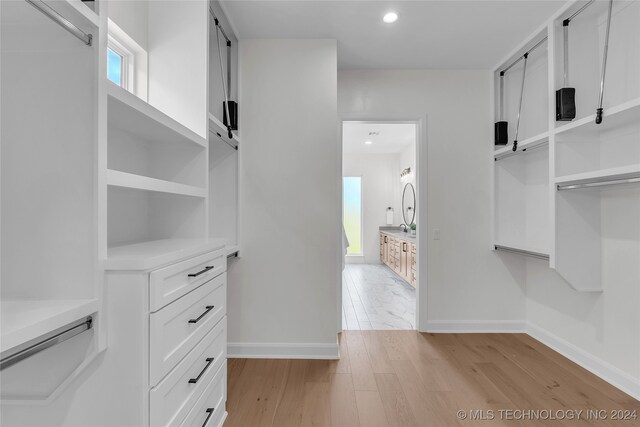 walk in closet featuring light hardwood / wood-style floors