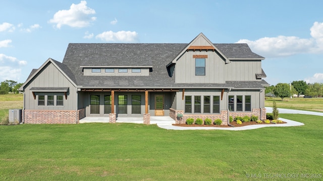 17599 S Harvard Ave, Mounds, OK 74047 - view of front of house featuring board and batten siding, a front lawn, roof with shingles, and brick siding