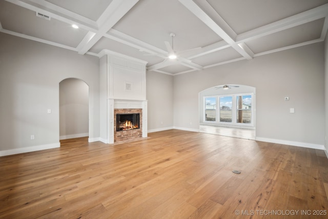 unfurnished living room with ceiling fan, wood-type flooring, coffered ceiling, and a brick fireplace