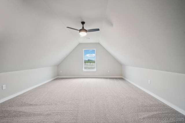 additional living space featuring lofted ceiling, ceiling fan, and carpet flooring