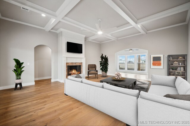 17599 S Harvard Ave, Mounds, OK 74047 - living room with ceiling fan, coffered ceiling, a fireplace, light wood finished floors, and beamed ceiling