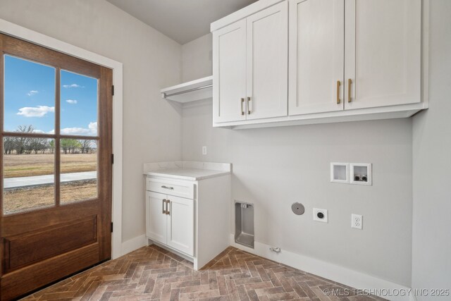 17599 S Harvard Ave, Mounds, OK 74047 - clothes washing area featuring hookup for an electric dryer, washer hookup, baseboards, cabinet space, and hookup for a gas dryer