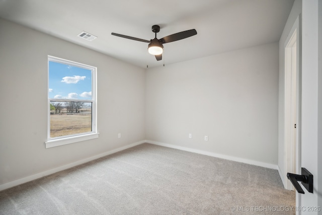 carpeted empty room featuring ceiling fan