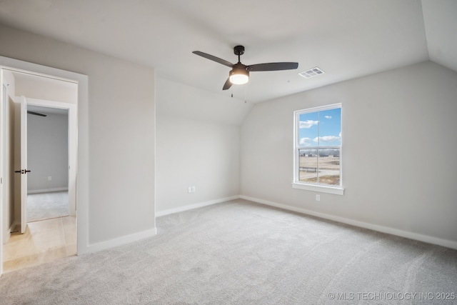 empty room with light carpet, vaulted ceiling, and ceiling fan