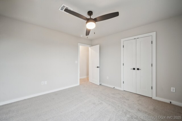 17599 S Harvard Ave, Mounds, OK 74047 - unfurnished bedroom with carpet, baseboards, a ceiling fan, and a closet