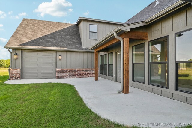 17599 S Harvard Ave, Mounds, OK 74047 - rear view of property featuring a shingled roof, a lawn, an attached garage, and brick siding