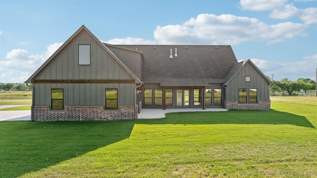 17599 S Harvard Ave, Mounds, OK 74047 - back of property featuring board and batten siding, a yard, brick siding, and a shingled roof