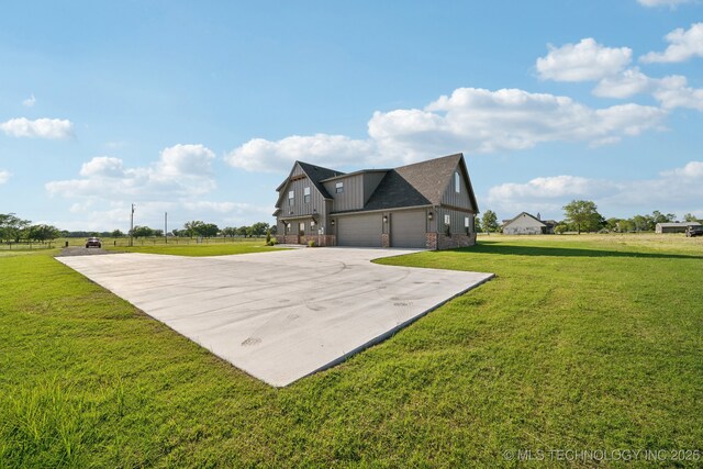 17599 S Harvard Ave, Mounds, OK 74047 - view of property exterior featuring concrete driveway, board and batten siding, a lawn, a garage, and a shingled roof