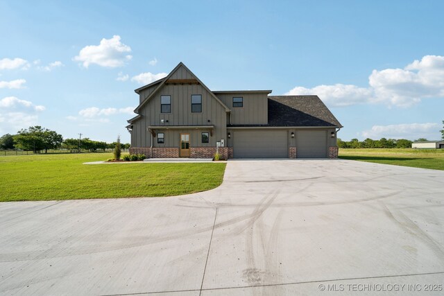 17599 S Harvard Ave, Mounds, OK 74047 - view of front of house featuring board and batten siding, a front yard, a garage, and concrete driveway