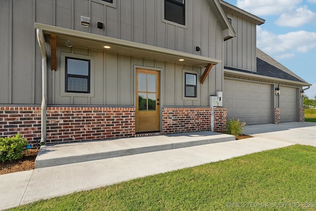 17599 S Harvard Ave, Mounds, OK 74047 - view of front of house with board and batten siding, brick siding, driveway, an attached garage, and roof with shingles