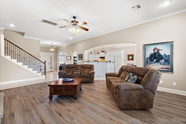 living room featuring ceiling fan, crown molding, and hardwood / wood-style floors