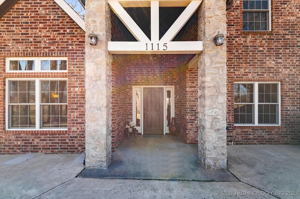 entrance to property with brick siding