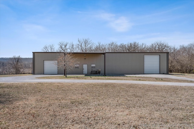 garage with wooden walls and a yard