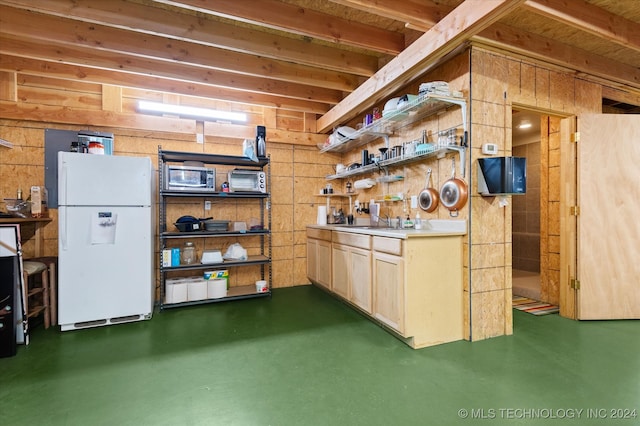 kitchen featuring light brown cabinets, sink, and white refrigerator