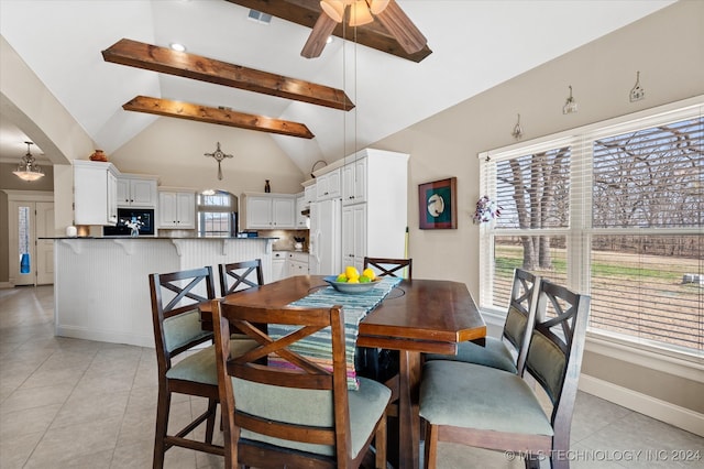 tiled dining space with beamed ceiling, ceiling fan, and high vaulted ceiling