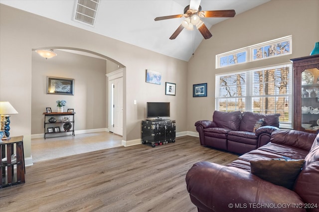 living room featuring ceiling fan, light hardwood / wood-style flooring, and high vaulted ceiling