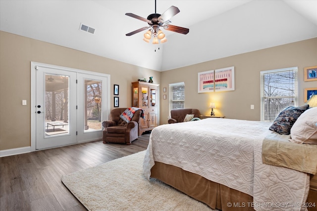 bedroom with multiple windows, access to outside, hardwood / wood-style floors, and ceiling fan