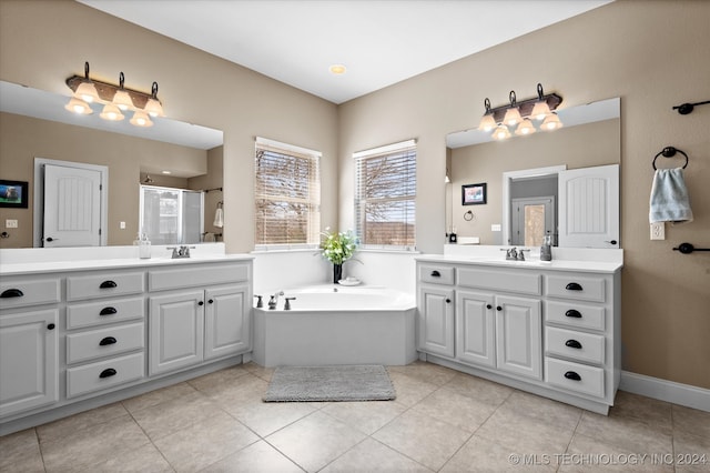 bathroom with independent shower and bath, vanity, and tile patterned floors