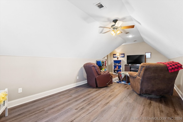 living room with wood-type flooring, vaulted ceiling, and ceiling fan