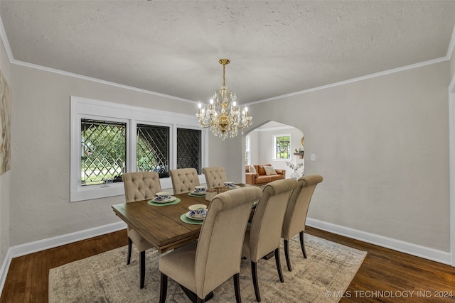 dining room featuring a healthy amount of sunlight, dark hardwood / wood-style floors, and a notable chandelier