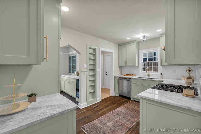 kitchen featuring dark hardwood / wood-style floors, green cabinets, stainless steel appliances, and sink